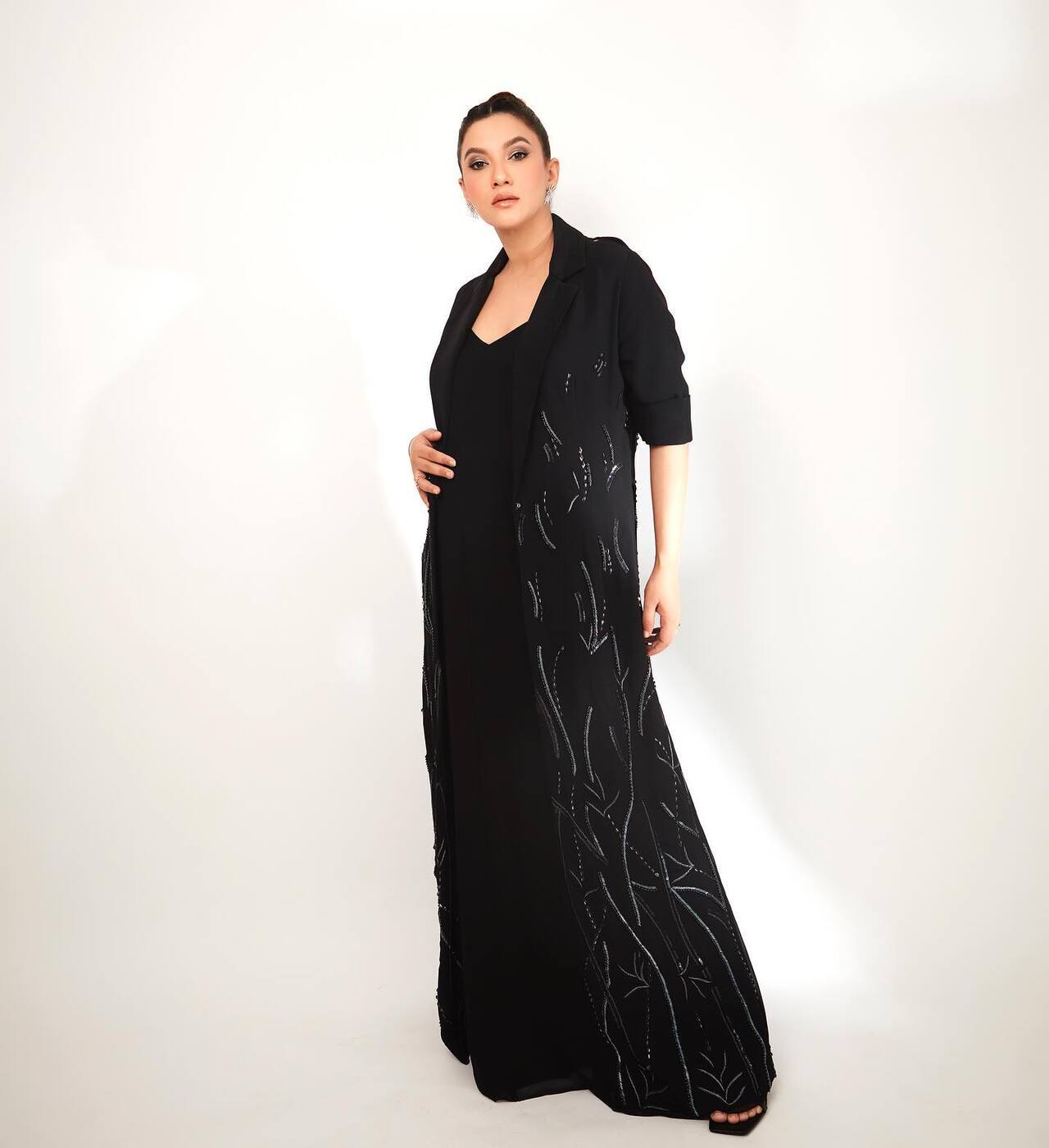 Beauty in black! Gauahar stuns in this chic all-black outfit featuring a long embellished jacket layered over a sleek dress.